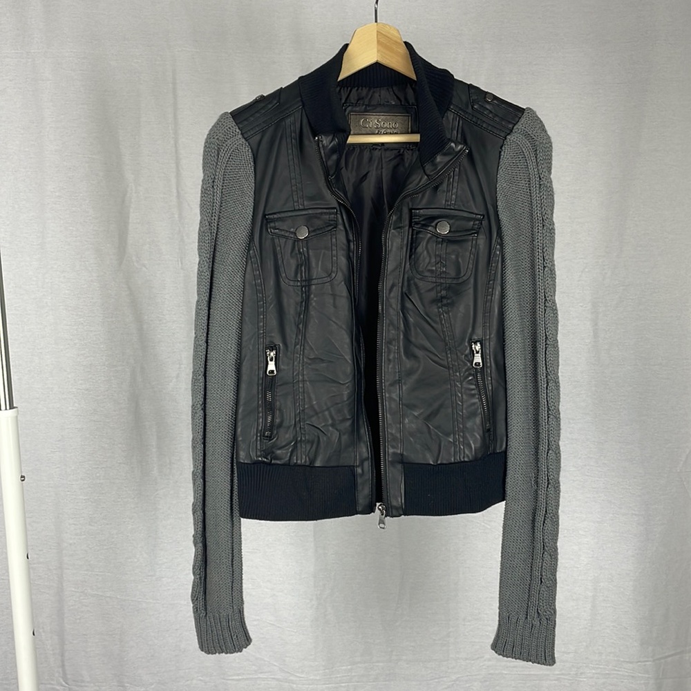Ci Sono Women’s Black Faux Leather Jacket with knitted dark grey sleeves…